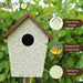 Birdhouse with green ivy design on a blurred natural background