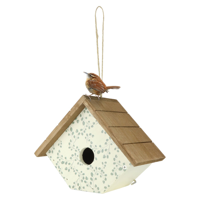 Decorative birdhouse with a bird perched on top against a white background