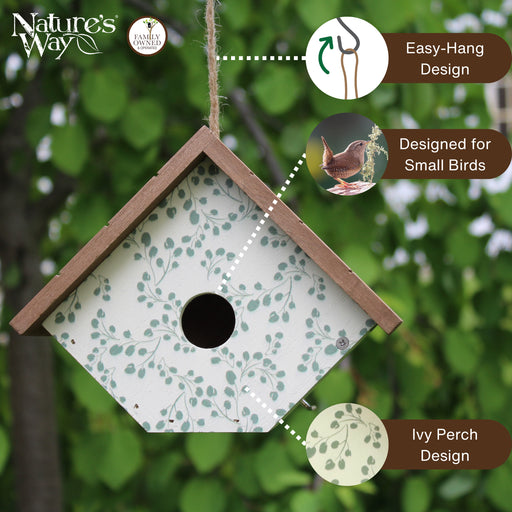 Birdhouse with green leaf pattern and 'Nature's Way' branding, set against a blurred green background.