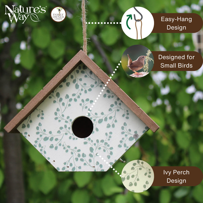 Birdhouse with green leaf pattern and 'Nature's Way' branding, set against a blurred green background.