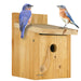 Wooden birdhouse with two bluebirds on a white background