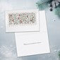 A close-up of a white greeting card with delicate pastel floral artwork at the top and a white lined writing area below, set against a soft light gray textured background.