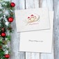 A holiday-themed wedding invitation card featuring a gold monogram and 'Love' script with a small red heart, displayed on a white wooden background next to a Christmas tree with red ornaments.